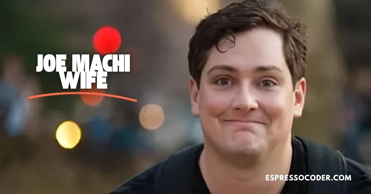 Joe Machi performing stand-up comedy on stage in signature dark blazer.