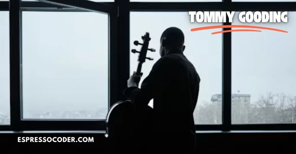 Tommy Gooding playing bass guitar on stage during a live R&B concert performance.